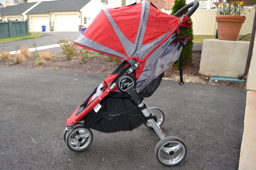 Three wheel stroller in the front yard