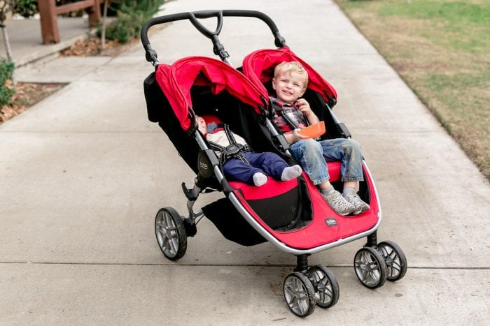 Two children in a double stroller. 