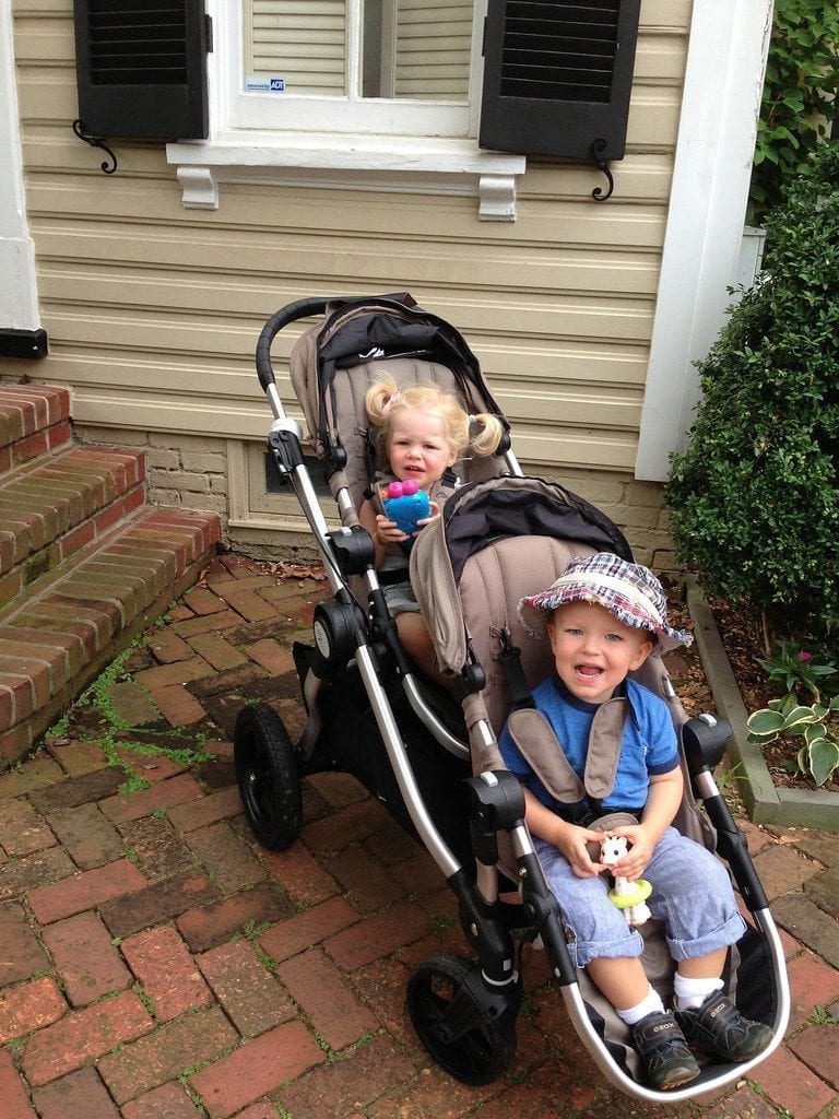 A double stroller with a front seat and back seat.