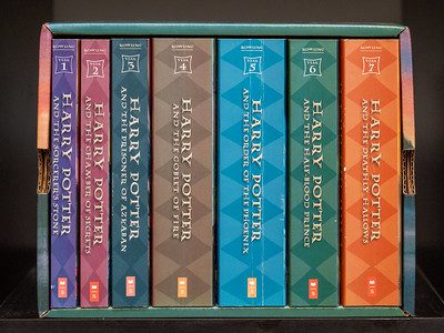 A stack of seven Harry Potter books, iconic spines and covers, top adventures. Great books for boys.
