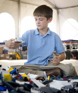 An image of a boy playing the top play things for twelve year old boys like him. Great for cognitive development. Toys for them.