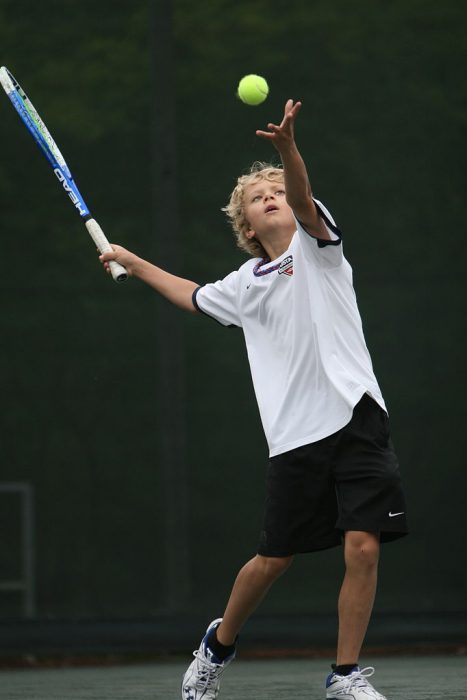 A boy playing tennis