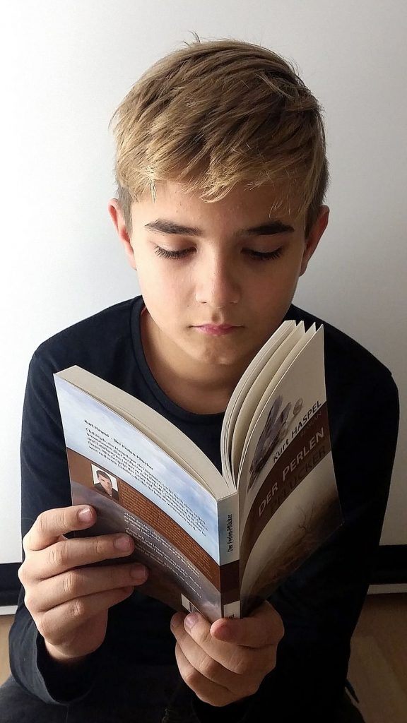 A teenager reading a book.