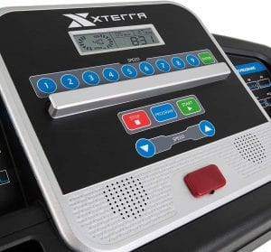Close-up view of a treadmill's console with the brand name XTERRA visible. XTERRA Treadmill displays various buttons for speed and program settings, a safety key, and a digital screen showing workout data.