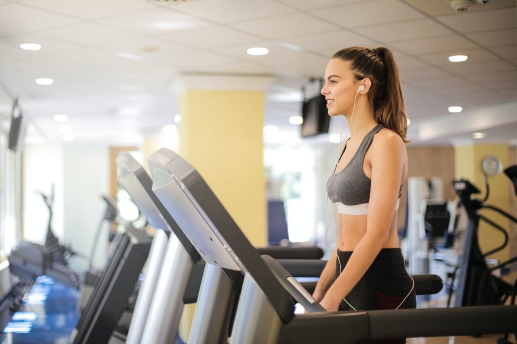 A woman keeping a fit and healthy body by doing treadmill exercise.