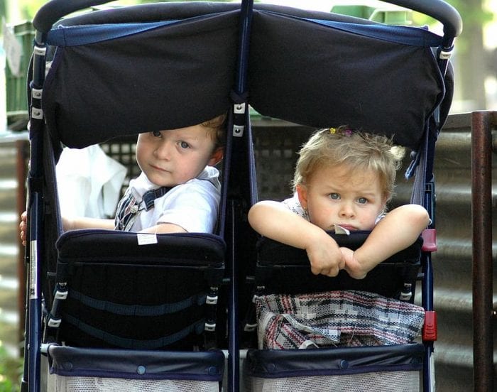 A pair of best child buggies strollers that have been thoughtfully assembled to the convenience and comfort of sizeable children. These carriages stand out due to their increased seating spaces and superior weight limits, affirming the strollers appropriateness on accommodating larger children. The two youngsters settled in the carriages appear entirely at ease, exemplifying the practicality of these specially designed best pushchairs and strollers.