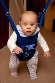 A cute, blonde baby smiling and bouncing on a baby jumper. It is the perfect toy for your active babies, much like Jumperoos