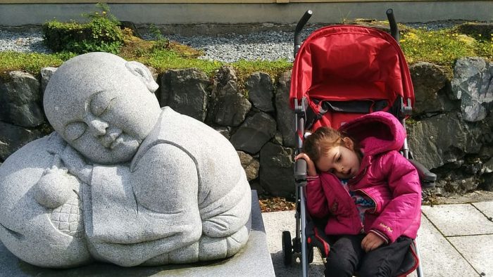 This photo shows how convenient it is to own stroller. Bigger kids can still sit and rest in it after a long walk with their parents.