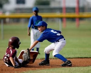 2 young boys in blue and maroon from different teams