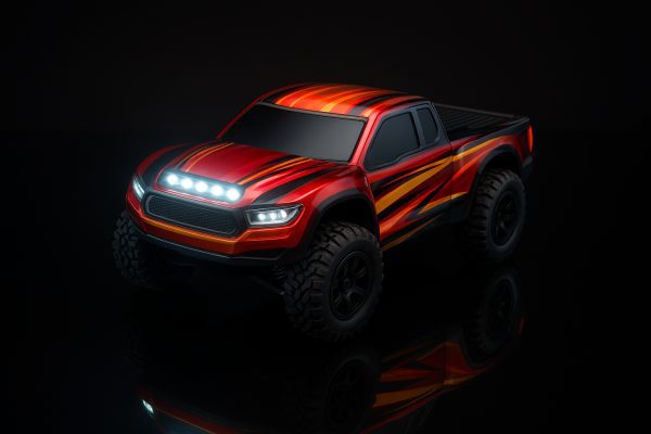Studio shot of a budget RC car\u2019s glossy custom body with glowing LED lightbar, reflected on a black surface.