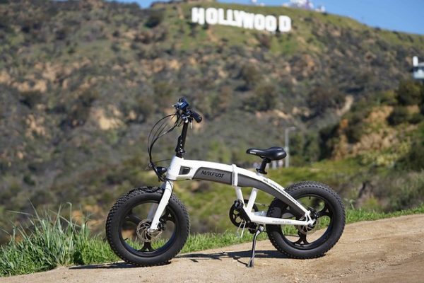One of the best electric bikes under a thousand dollars is parked in the side of a rural road.