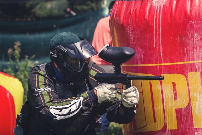 A focused young man aiming his target with precision using his toy gun, one of his gifts, showcasing determination and playfulness in a dynamic and engaging scene.