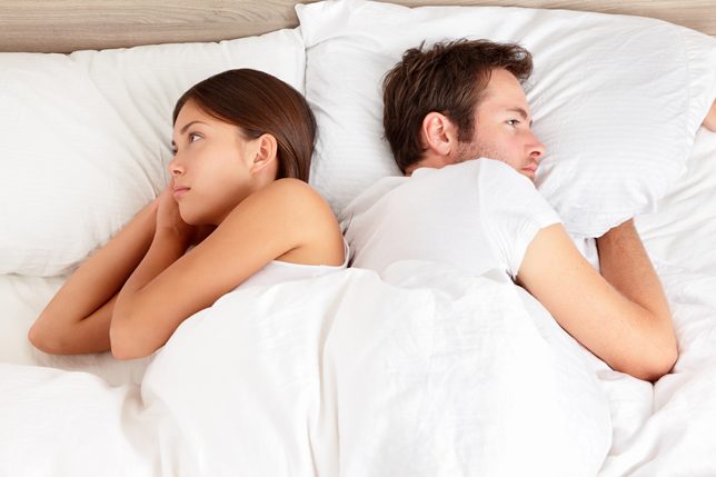 Couple sharing in a twin mattress bed