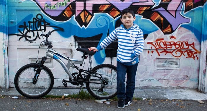boy posing with his 20 inch bike