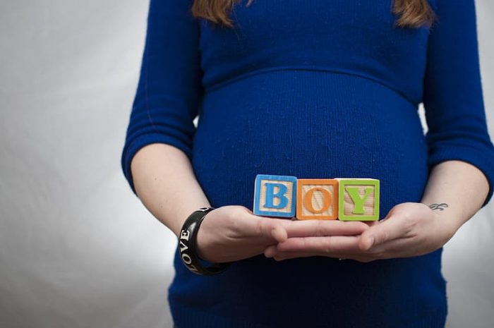 Baby names - A pregnant holding 3 cubes saying "BOY". Depending on whether it's a boy or a girl, there are a lot of names you can choose from different origins and with different meanings. Choose names wisely.