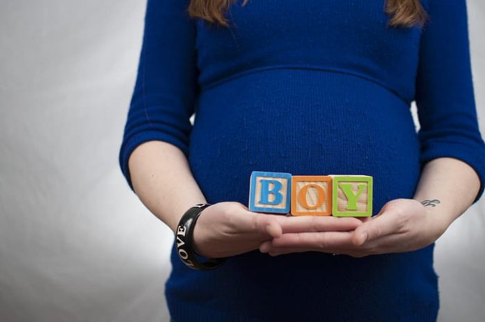 Baby names - A pregnant holding 3 cubes saying "BOY". Depending on whether it's a boy or a girl, there are a lot of names you can choose from different origins and with different meanings. Choose names wisely. 