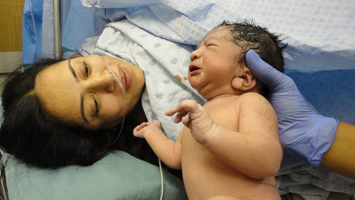 Baby names - A mom and a newly born baby. She perhaps thinking on the perfect baby names meaning wish. The baby is crying. The baby can be hungry.