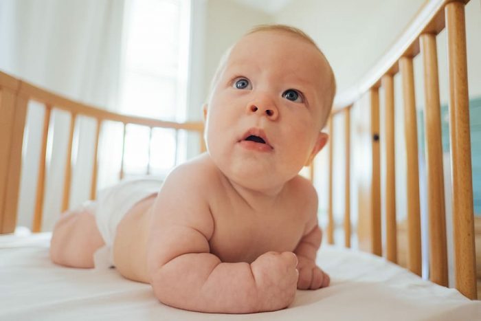 An infant inside his crib.