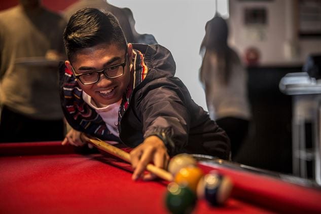 Aged 14 boy playing billiard for fun