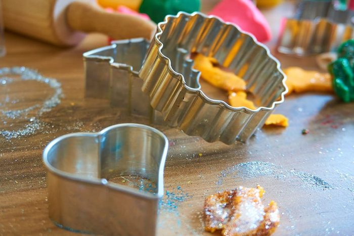 Play-Doh rollers and cookie cutters enhance creativity.