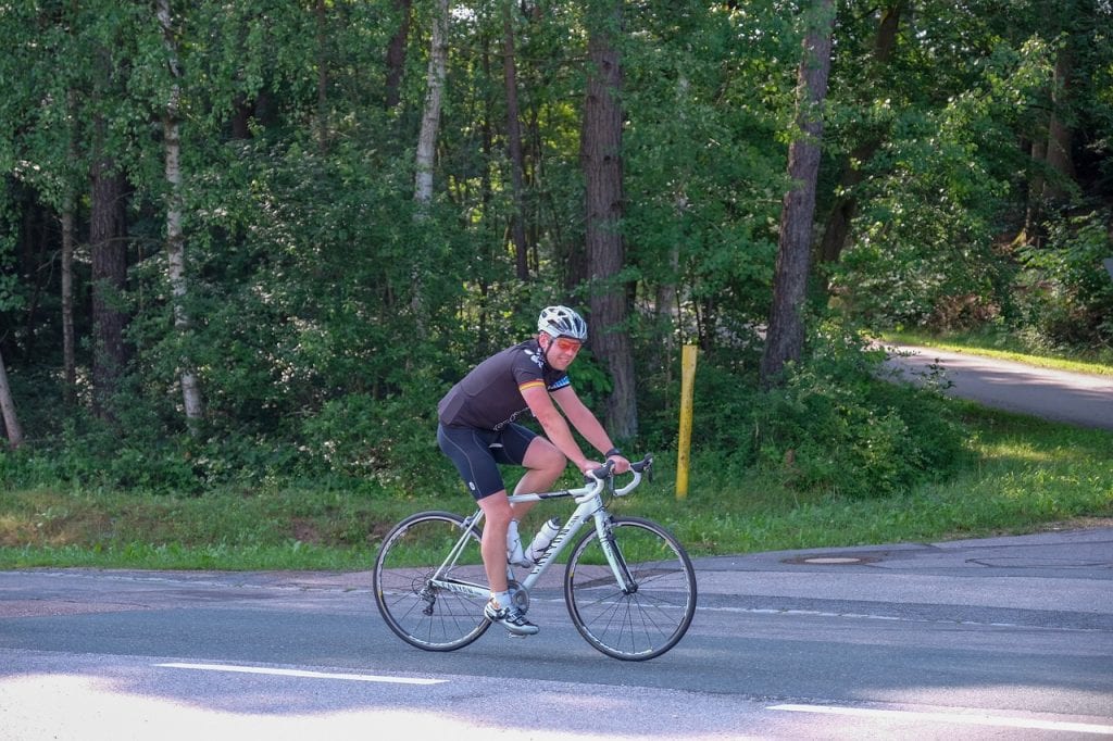 Man on bicycle with helmet and cycling goggles