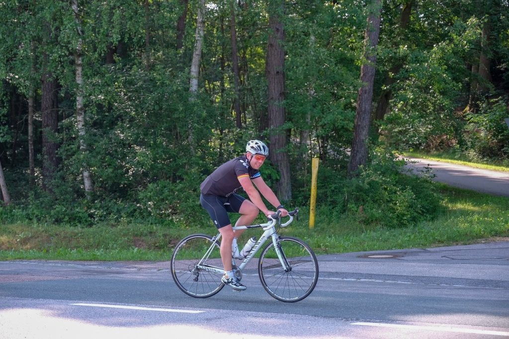 Man on $500-worth road bicycle with helmet and cycling goggles