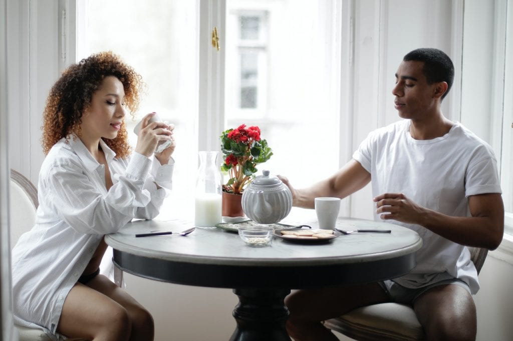 An expecting woman having a healthy drink during breakfast