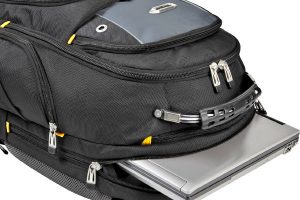 Backpack: Black laptop backpack with multiple compartments and zippers, showcasing a laptop being slid into a padded sleeve, ideal for nursing students' tech needs.