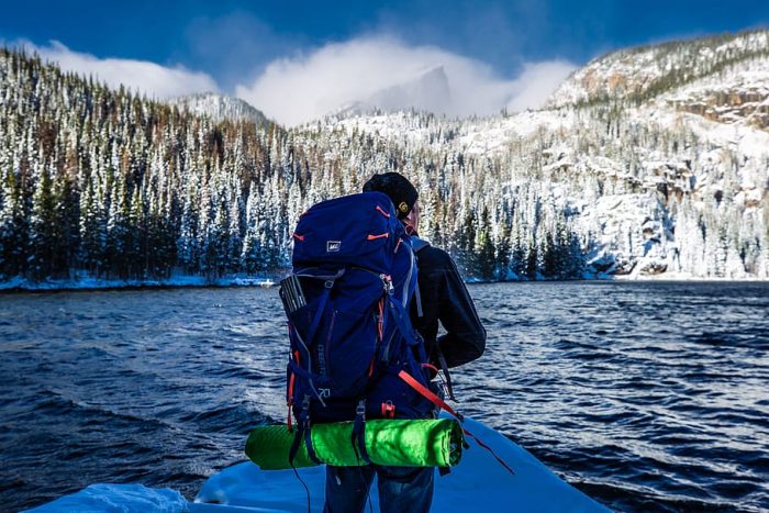 A man has a big bag under $100 during his hiking adventure