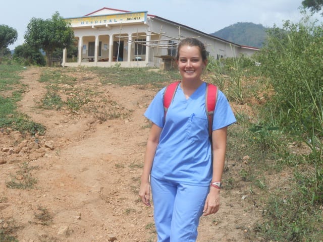 girl in hospital pajamas posing in front of a hospital