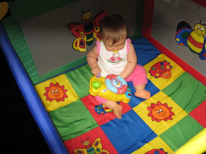 A baby playing in a comfortable and secured space