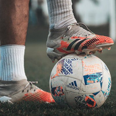 A player wearing a different pair of Adidas soccer cleats.