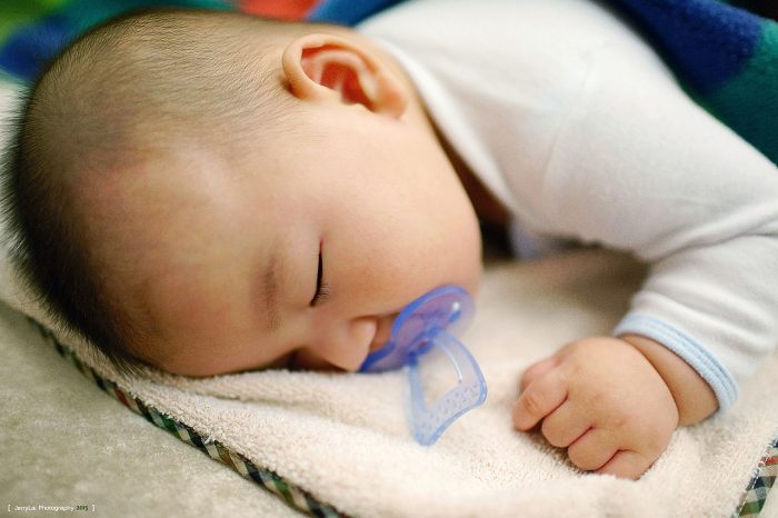 baby rolls over in sleep and cries