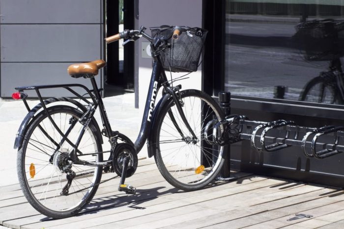 One of the most affordable bikes is parked outside the shop: Riding a bicycle to school not only provides a cost-effective and environmentally friendly mode of transportation but also promotes physical activity, contributing to improved overall health and well-being. Additionally, cycling allows students to enjoy the outdoors, fostering a sense of independence and a positive start to the day.