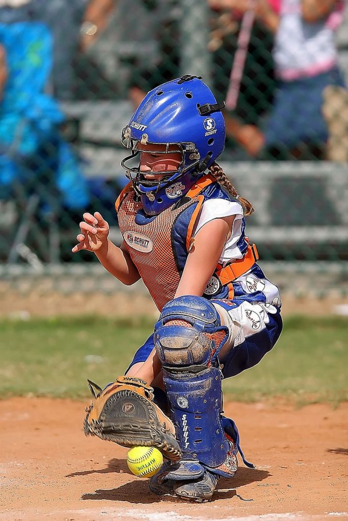 A girl wearing a catchers mitt