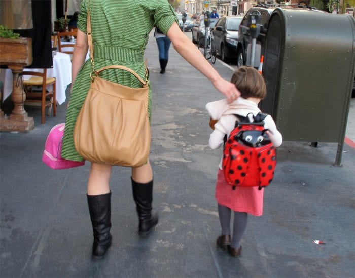 Mom and daughter carrying their own bags.