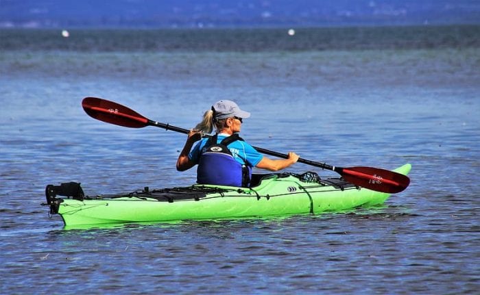 Woman with a kayak paddle.