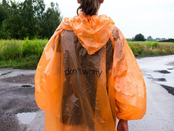 A woman wearing rain poncho for backpacking