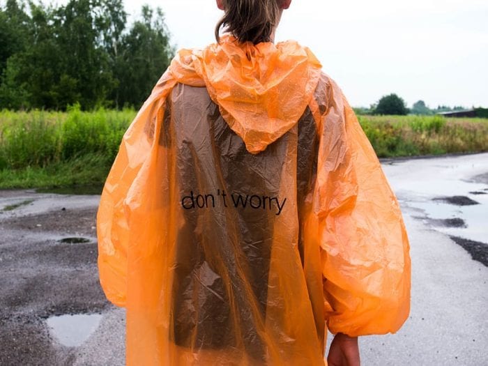 A woman wearing the poncho during wet weather hiking