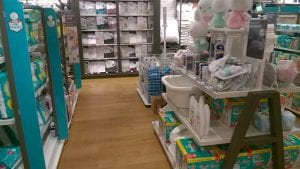 A department store with many baby products such as diapers, baby soap and shampoo, stuffed animal toys, blankets and many other.