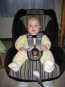 A car seat for babies. There is a car seat and a cute little baby on it. Boulevard versus marathon.