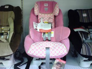 A pink variant of britax car seat. It has harness and adjustable headrest. 