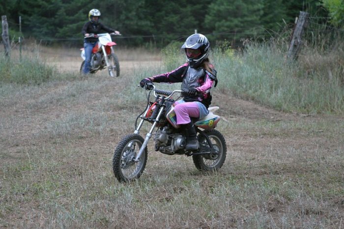 Trailer riders are riding their Dirt MX650 bikes. The sleek and powerful Dirt Rocket MX650 bikes stand proudly in dirty trail.