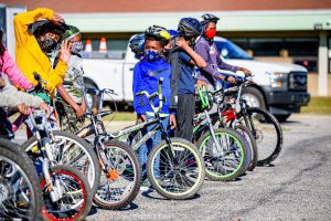 A group of kids with their bikes.