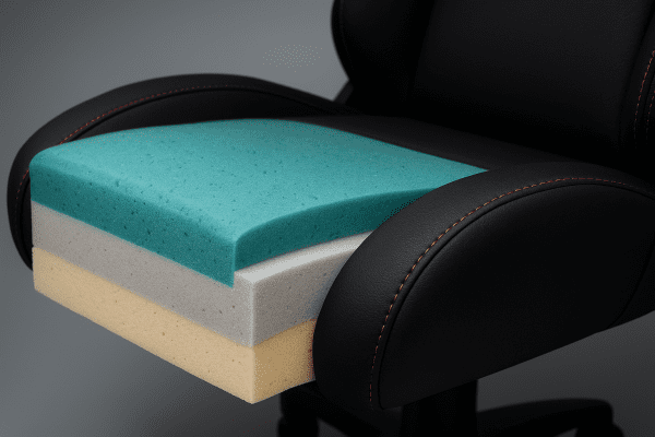 Extreme macro of gaming chair cushion, showing gel memory foam, cold-molded foam, and base foam layers in a clean cross-section.