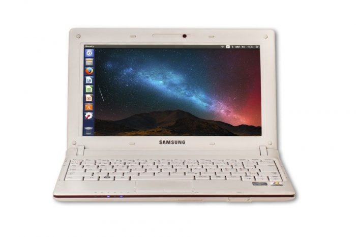 A Samsung brand PC with a white cover and a colorful wallpaper with a mountain and starry skies on it.