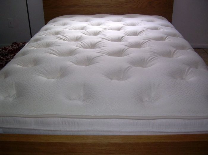 A white best mattress with holes