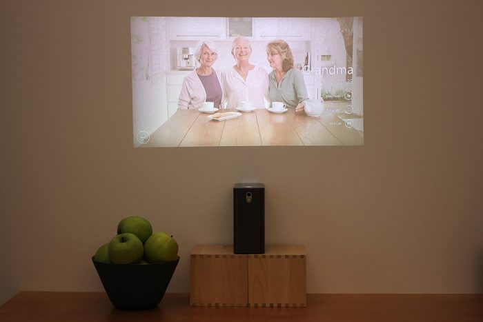 Watch a movie using a smart projector. Image and video quality is important when choosing one.