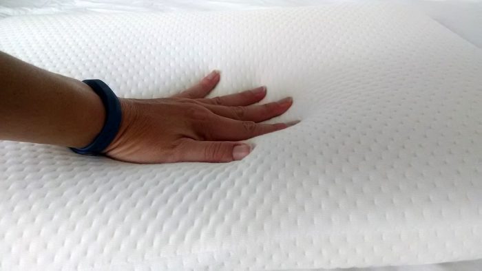 When a hand presses down on a memory foam mattress, the material responds by contouring to the shape of the hand. Memory foam is designed to be highly responsive to pressure and heat. As the hand applies pressure, the memory foam compresses and molds around the hand's shape, creating a temporary indentation.