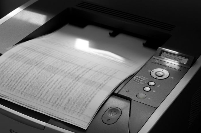 A printer is printing a black and white document. These kinds of printers are superb.